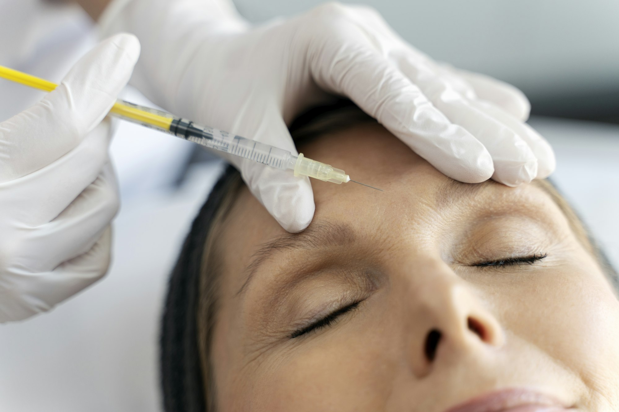 Close up view of the cosmetologist does prp therapy on the face of elderly woman